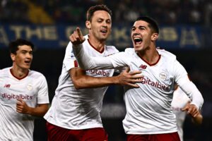 A Romas Italian forward Cristian Volpato (R) celebrates after he scored a second goal for his team during the Italian Serie A football match between Hellas Verona and AS Roma at the Marcantonio Bentegodi Stadium in Verona on October 31, 2022. (Photo by MARCO BERTORELLO / AFP) (Photo by MARCO BERTORELLO/AFP via Getty Images)