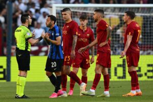 Italian referee Fabio M%aresca (L) speaks to Inter Milan's Turkish midfielder Hakan Calhanoglu (2ndL) during the Italian Serie A football match between AS Rome and Inter Milan on May 6, 2023 at the Olympic stadium in Rome. (Photo by Vincenzo PINTO / AFP) (Photo by VINCENZO PINTO/AFP via Getty Images)